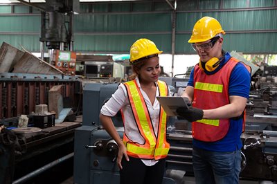 Engineers explaining plant floors with a tablet