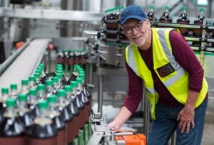 Factory worker quality checking beverages
