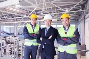 Three construction workers posing