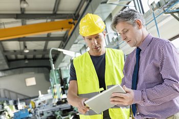 Supervisor worker explaining with a tablet