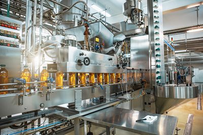 Bottles in a line at a production factory 