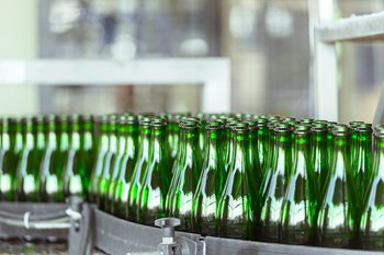 Green bottles on conveyor belt 