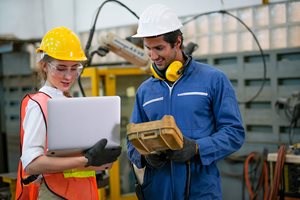 worker looking at plant floors on laptop