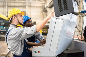manufacturer worker explaining to his coworker