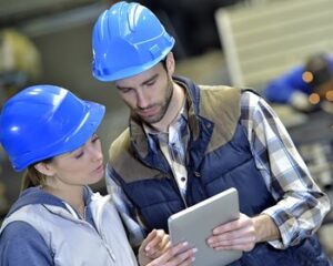 Coworker showing reports and analysis on a tablet