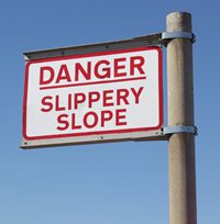 Road sign showing "danger, slippery slope"
